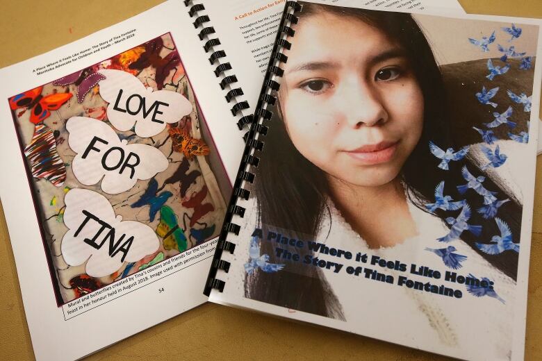 A bound booklet has a cover with a picture of a young girl on it. Beside it is another book with the words 