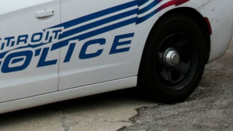 The side of a Detroit police cruiser is shown.  