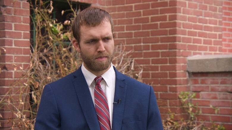 beared man in shirt and tie