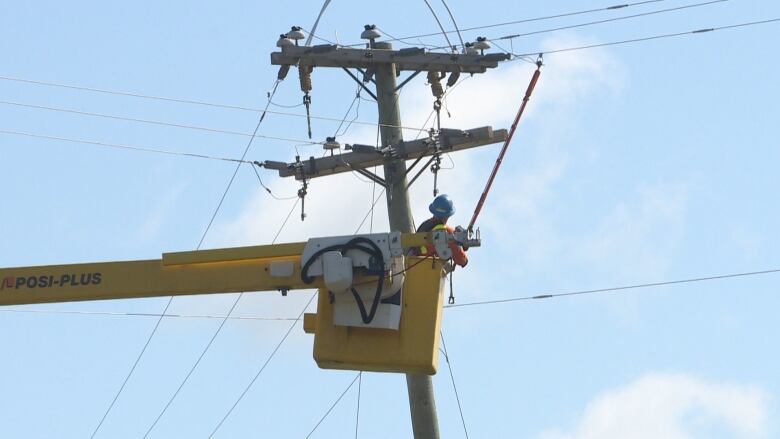 Crew working on an electricity pole.