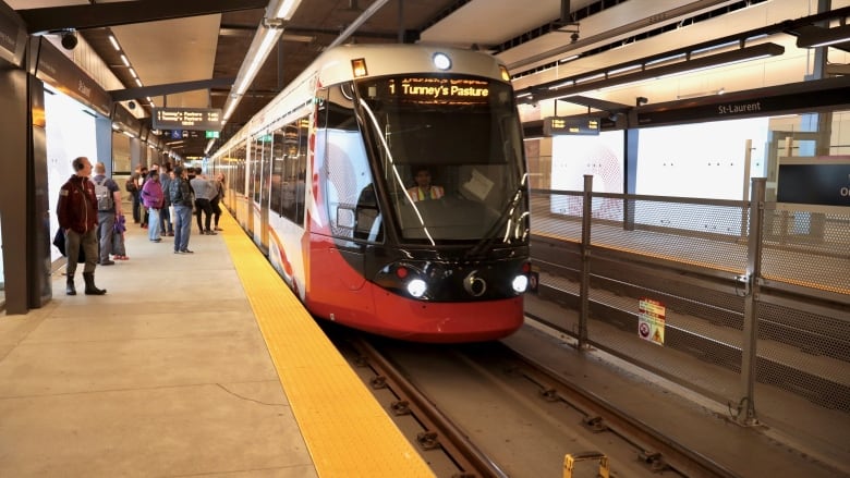 A train rail car sits at a underground transit platform.