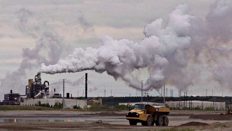 A dump truck works near the Syncrude oil sands extraction facility near the city of Fort McMurray, Alta., on June 1, 2014.