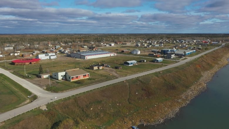 An aerial shot of a river, roads and buildings.