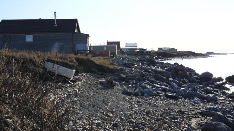 Houses are seen near a rocky northern coast.