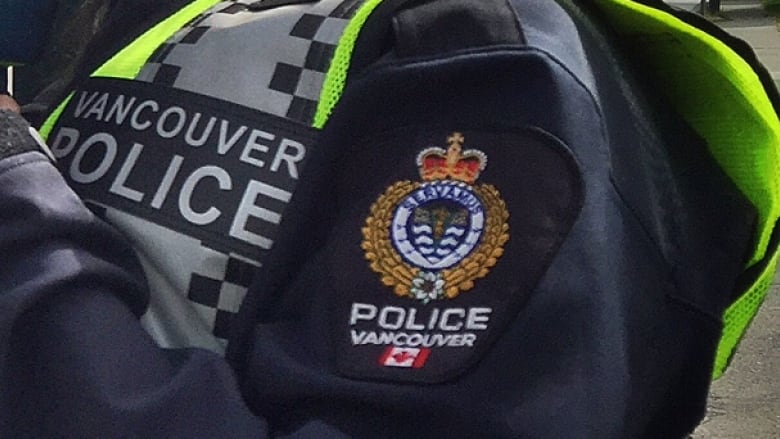 Vancouver Police Department logo on an officer's jacket sleeve.