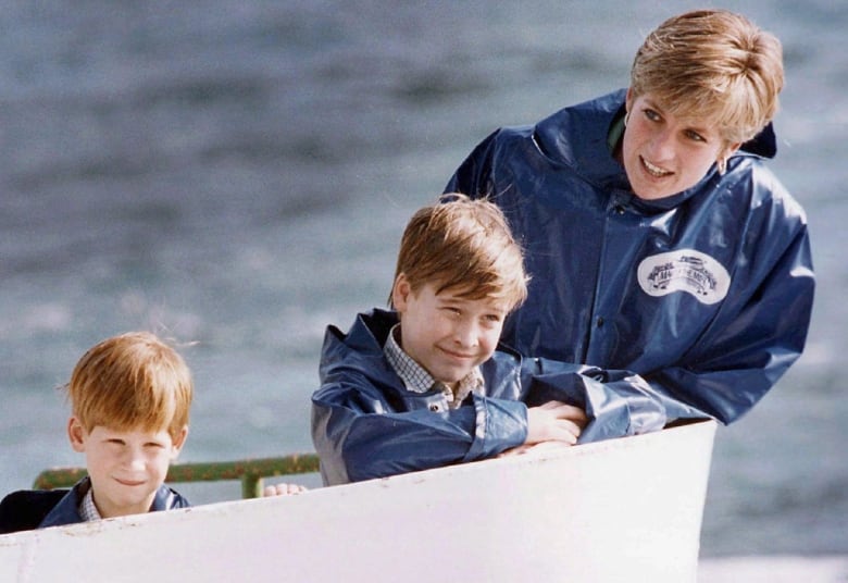 Woman and two young boys on a boat