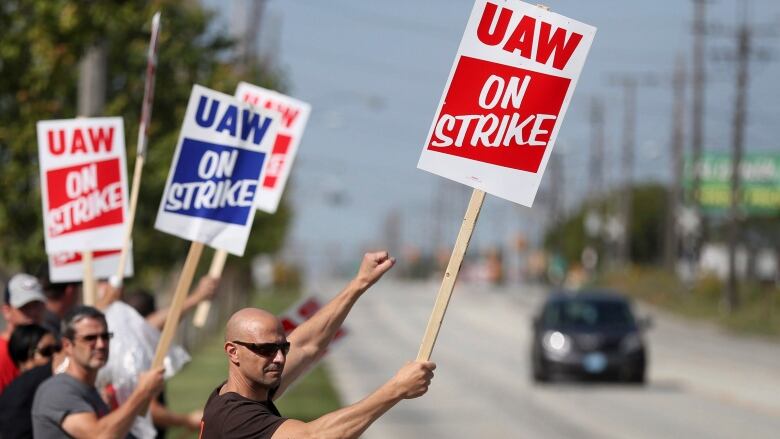 Carl Cvetkovich, front, joins dozens of fellow striking UAW workers outside the GM Parma facility in Parma, Ohio, Monday, Sept. 16, 2019. 