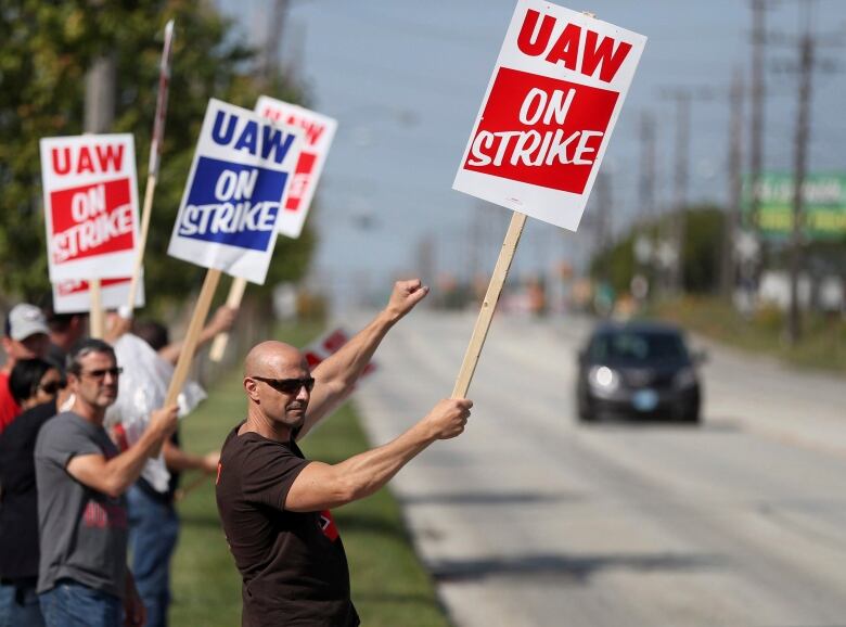 Carl Cvetkovich, front, joins dozens of fellow striking UAW workers outside the GM Parma facility in Parma, Ohio, Monday, Sept. 16, 2019. 