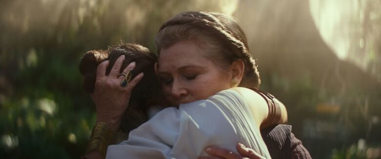 Actor Carrie Fisher hugs Daisy Ridley in a still from the film Star Wars: The Rise of Skywalker.