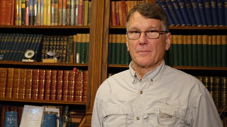 A man in a beige shirt.