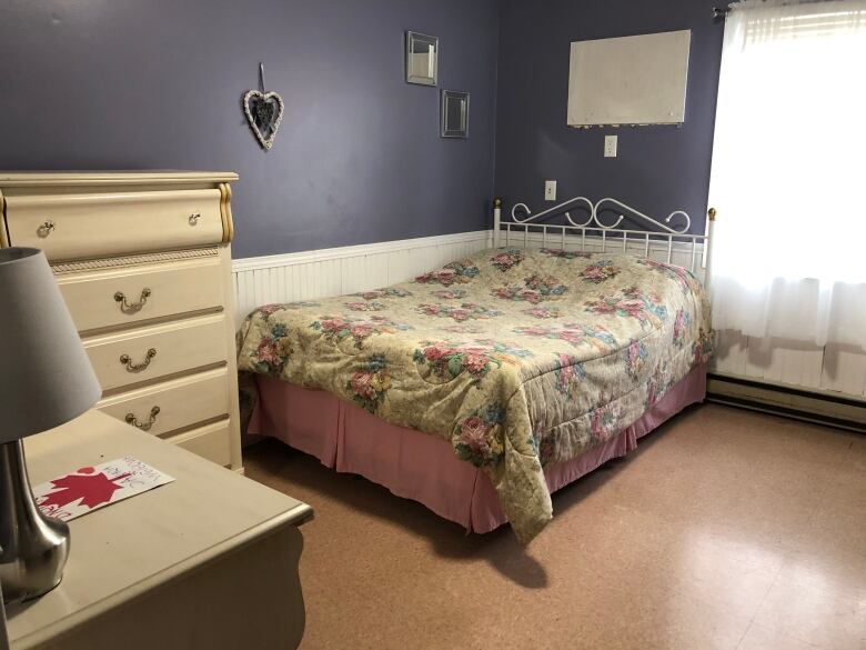 A double bed with a yellow duvet cover. 