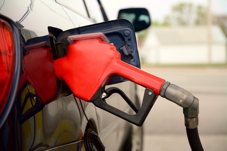 A gas pump nozzle in a gas tank.