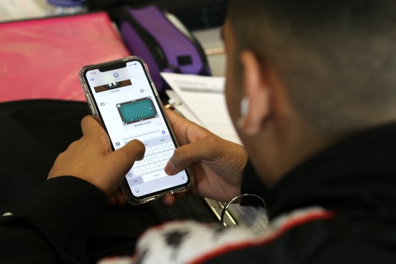 A kid texting using a cellphone.