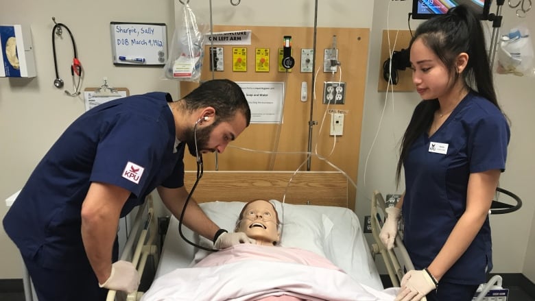 nursing students work on mannequin