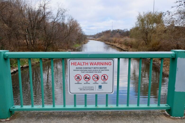 A sign on a bridge.