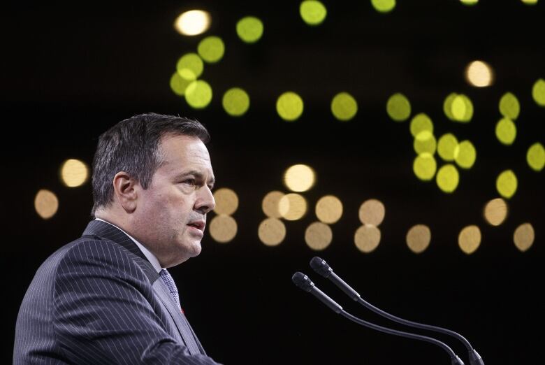 A man speaks at a podium.