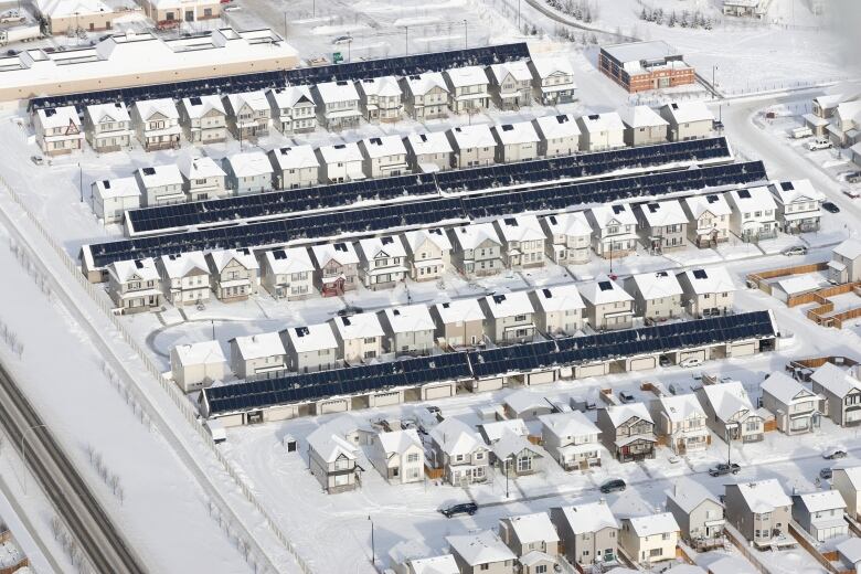 Aerial shot of a subdivision of snow-covered houses