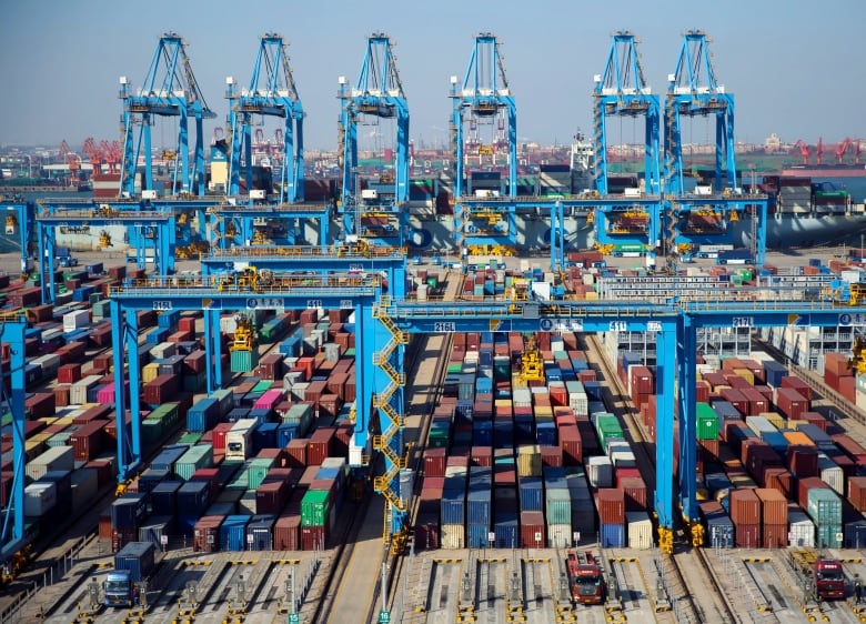 Hundred of shipping containers at a port.