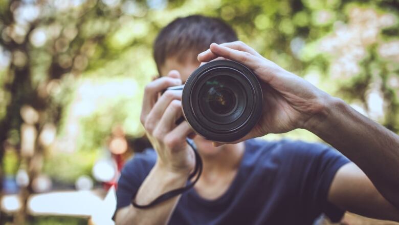 A photographer behind the lens of his camera.