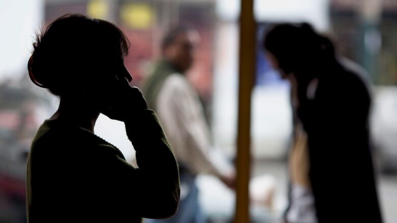 Pedestrians talk on their cellphones in Lima, Peru, on Monday, Aug. 1, 2016. Under a July 2015 decree, police now track cellphone locations without a court order but would need one to listen in. All four Peruvian phone companies are cooperating. They signed a pact with the government in Octoboer the details of which were not disclosed.