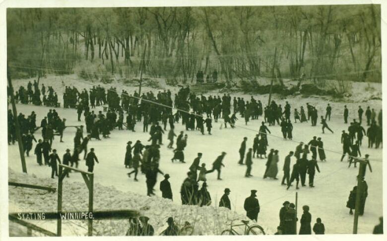 Black and white photo of people skating on a river