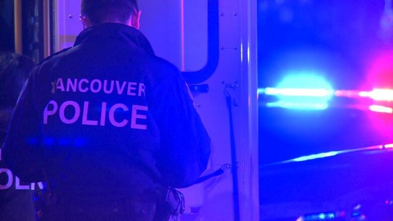 A cop with a jacket that reads 'Vancouver Police'.