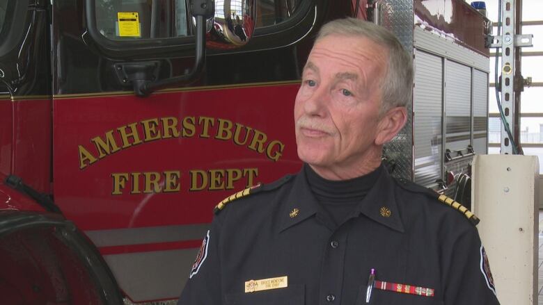 The town's fire chief stands in front of an Amherstburg, Ont., fire truck.