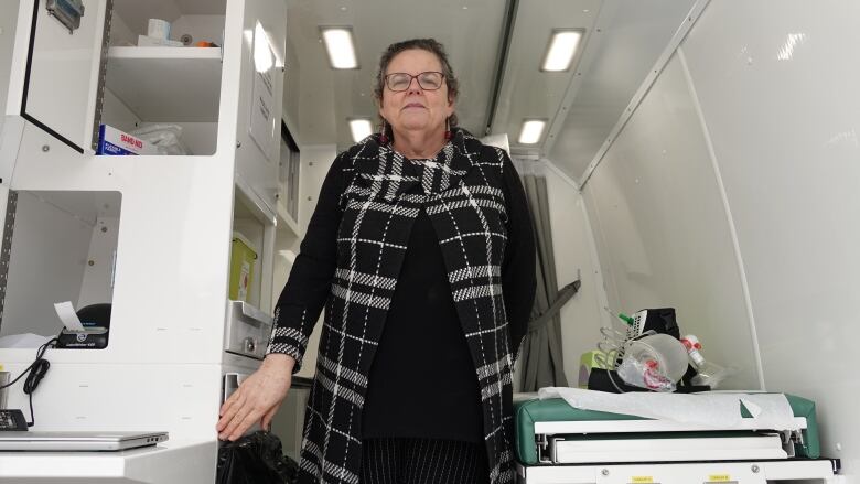 Wendy Muckle stands inside a van that provides healthcare services to drug users at one of Ottawa's supervised injection sites.