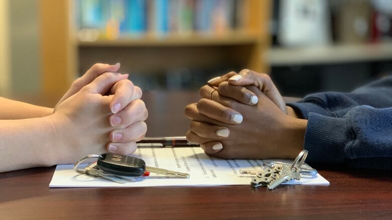 Two people sitting across from each other.