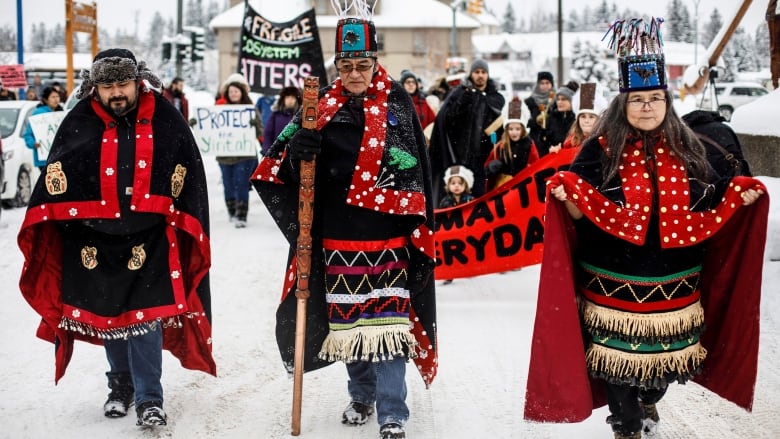 Three people in ceremonial dress.