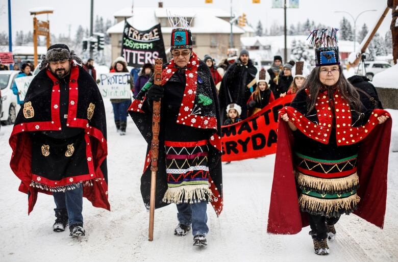 Three people in ceremonial dress.