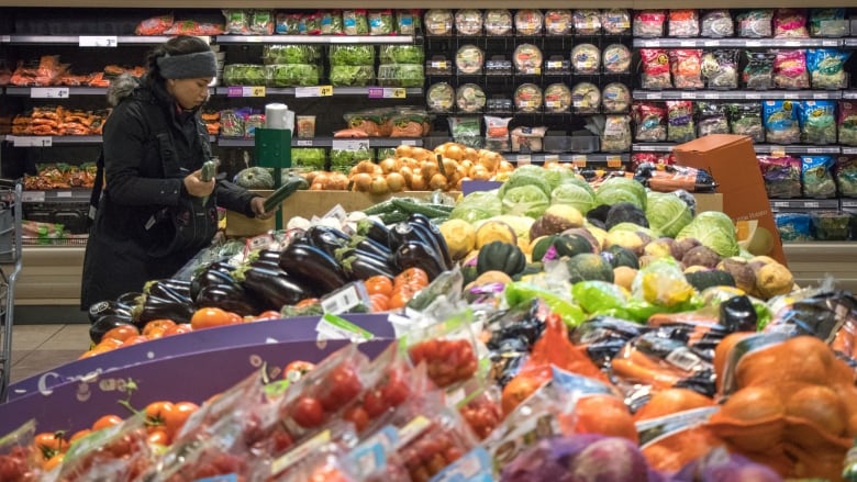 A woman shops in a grocery store.  