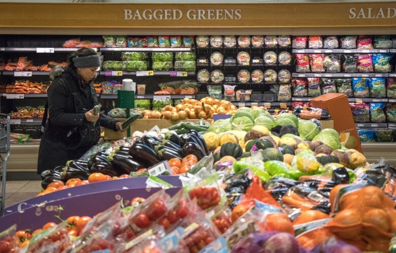 A woman shops in a grocery store.  