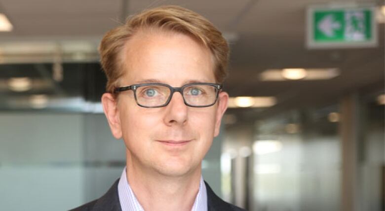 headshot of man with glasses