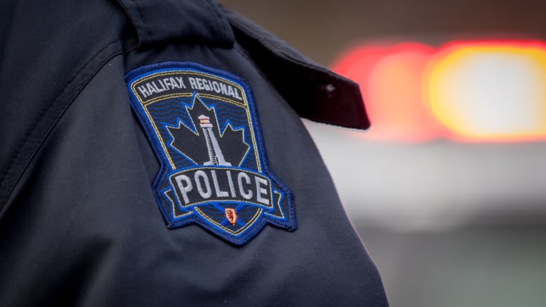 The badge of the Halifax Regional Police is seen on the sleeve of a navy blue shirt.