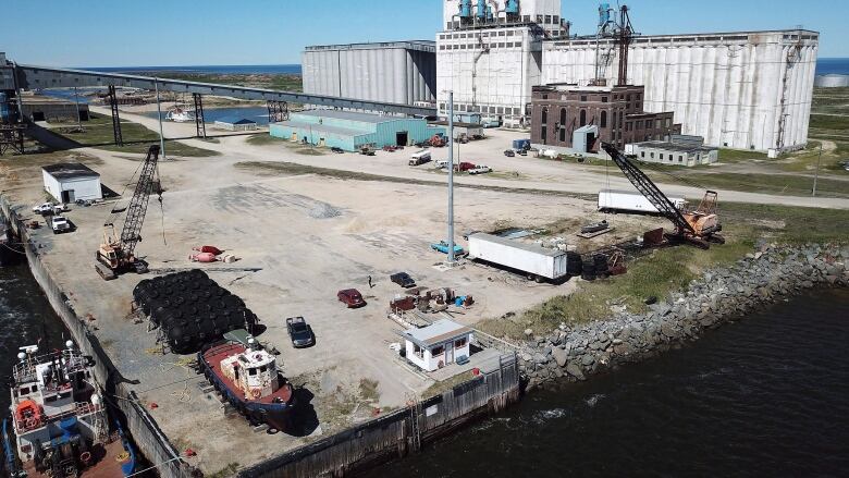 An aerial shot shows a large industrial port.