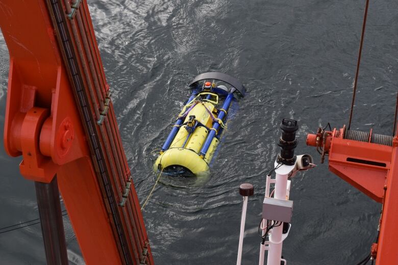 A large, yellow devide is submerged in the Labrador Sea. It takes chemical measurements in the water column to collect data useful for scientists.