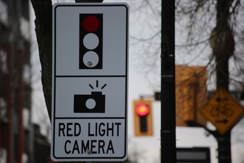 road sign reading red light camera