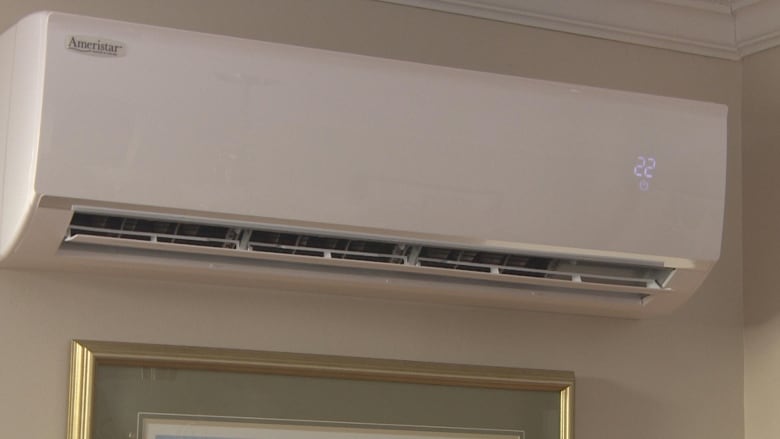 A white heater unit mounted to a wall. 