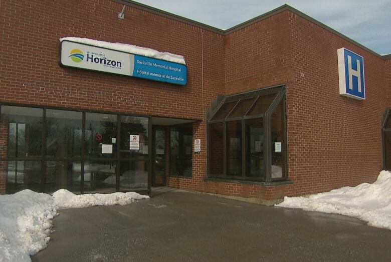 A brick building features a large letter H on the right and a sign for Horizon Health above the main door. Snow is on the ground. 