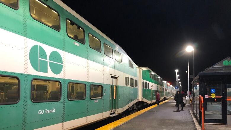 Riders board a GO train at the Acton, Ont., station on Wednesday, January 15, 2020.