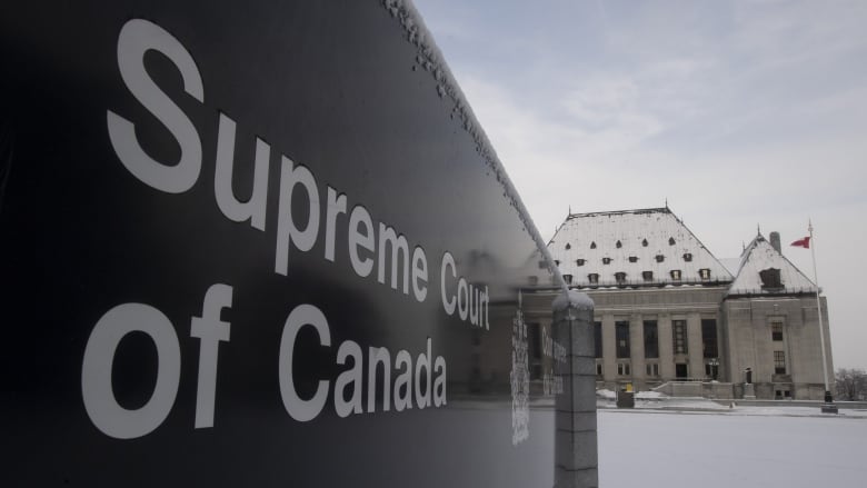 A sign reads 'Supreme Court of Canada' with snow on the ground and the court building in the background