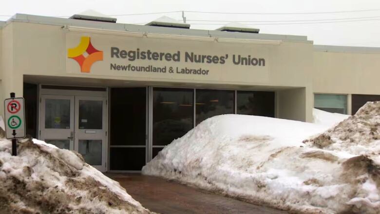 The office building of the Registered Nurses' Union of Newfoundland and Labrador.A snowbank piles on either side of the walkway toward the building.