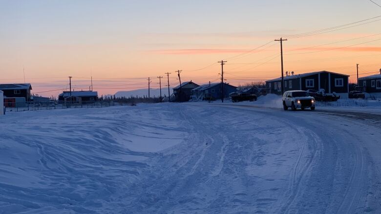 The sun sets in a northern community in winter.