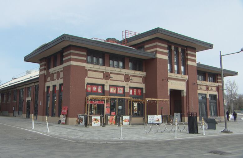 A brick multipurpose building in a city park.