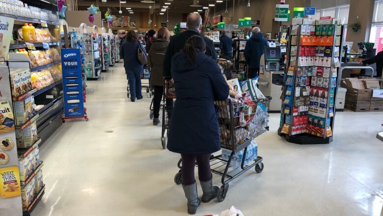 Shopping carts in line at grocery store.