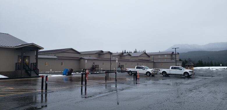 An industrial work camp is seen with modular temporary rows of buildings.