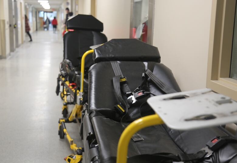 A stretcher sits in a hallway.