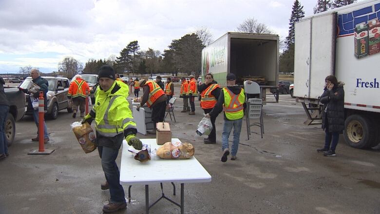 Volunteers with the Island Producers Helping Islanders campaign hand out free potatoes, cheese and milk in Charlottetown on Saturday. 