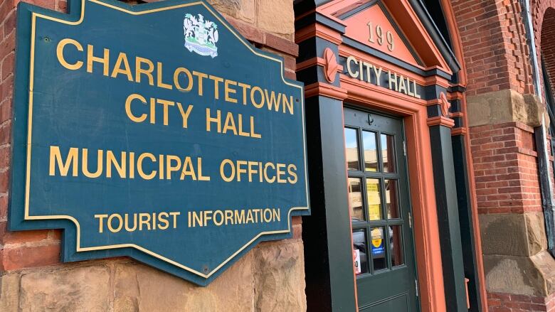 A close up photo of Charlottetown City Hall with a sign that reads Charlottetown City Hall Municipal Offices. 